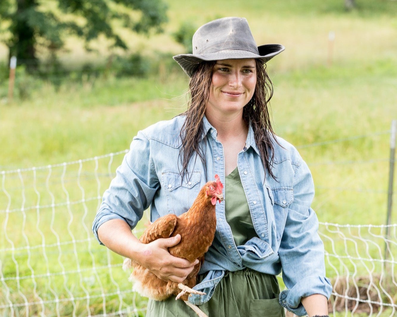 Woman holding chicken.jpg__PID:61fe27e5-cbae-477e-9d30-bf28fffa9013